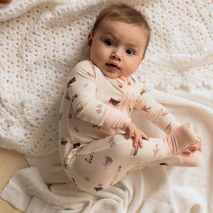 Baby wearing transportation-themed onesie — The Earhart organic cotton bodysuit