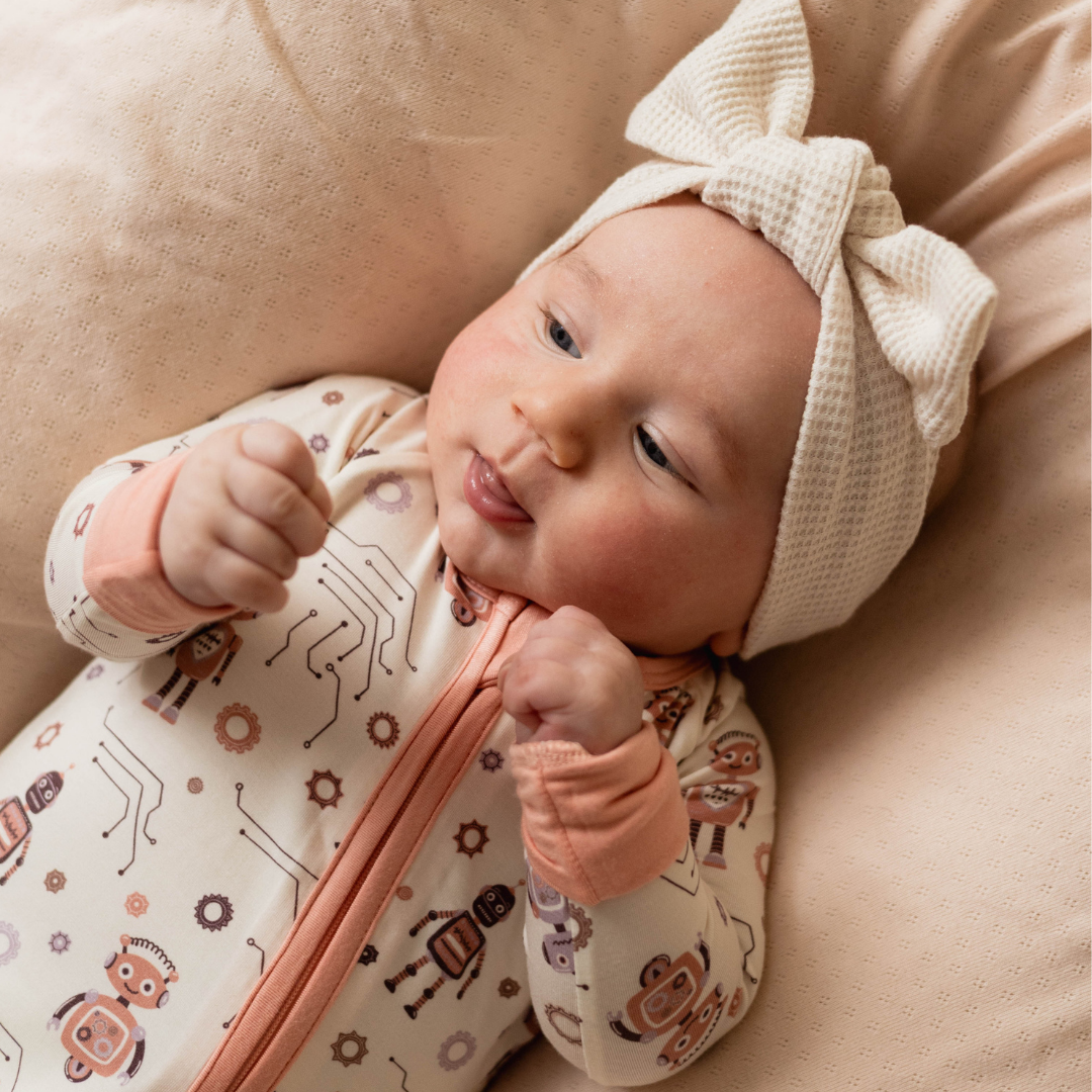 Robot baby onesie flat lay — organic cotton with robot and tech print
